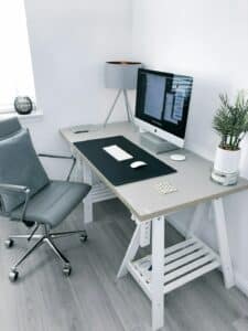 gray leather office rolling armchair beside white wooden computer desk
