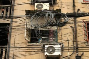 a building with lots of wires hanging from it's sides